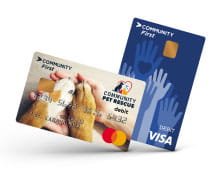 close-up of two credit cards, one blue with hand icons reaching out and the other with a human hand and a pair of dog paws